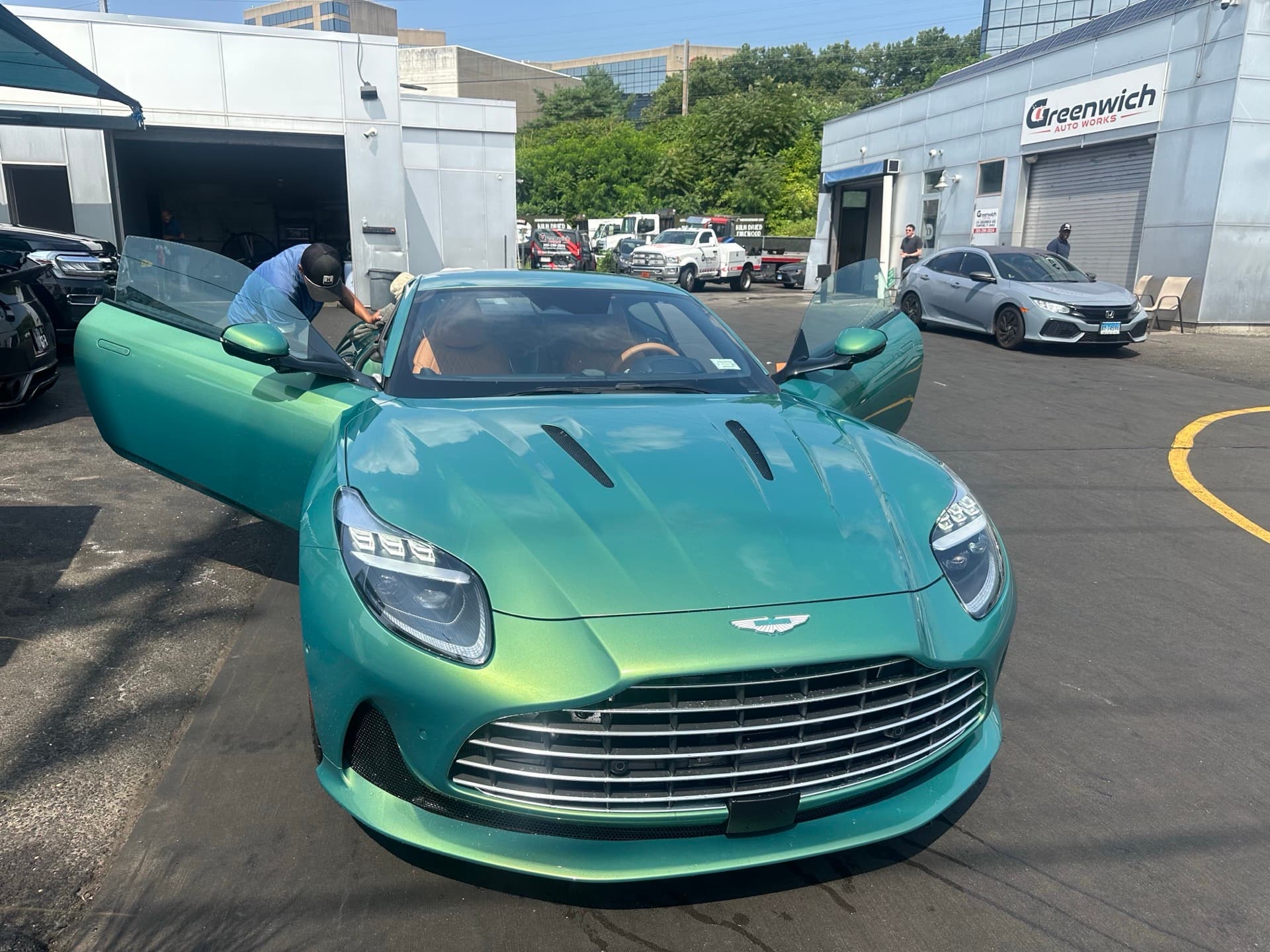 Turquoise Aston Martin DBX being serviced