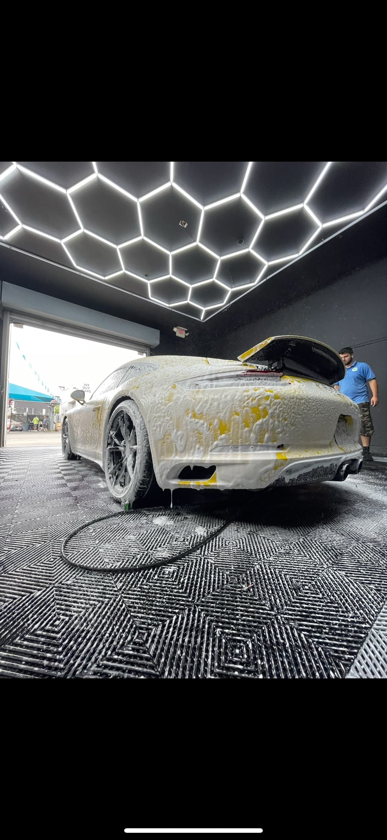 White sports car foam wash with hood open