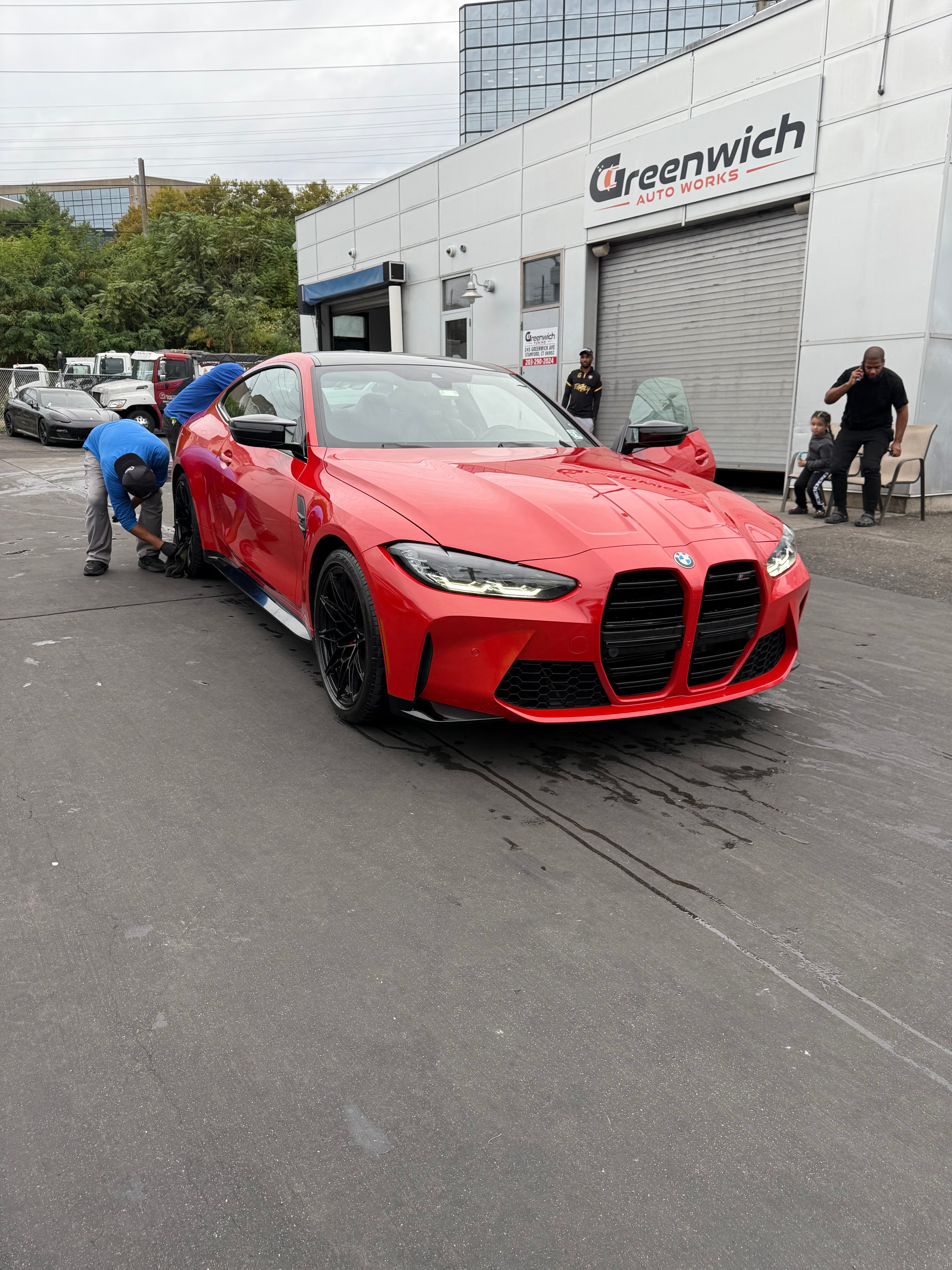 Red BMW M4 being hand-dried