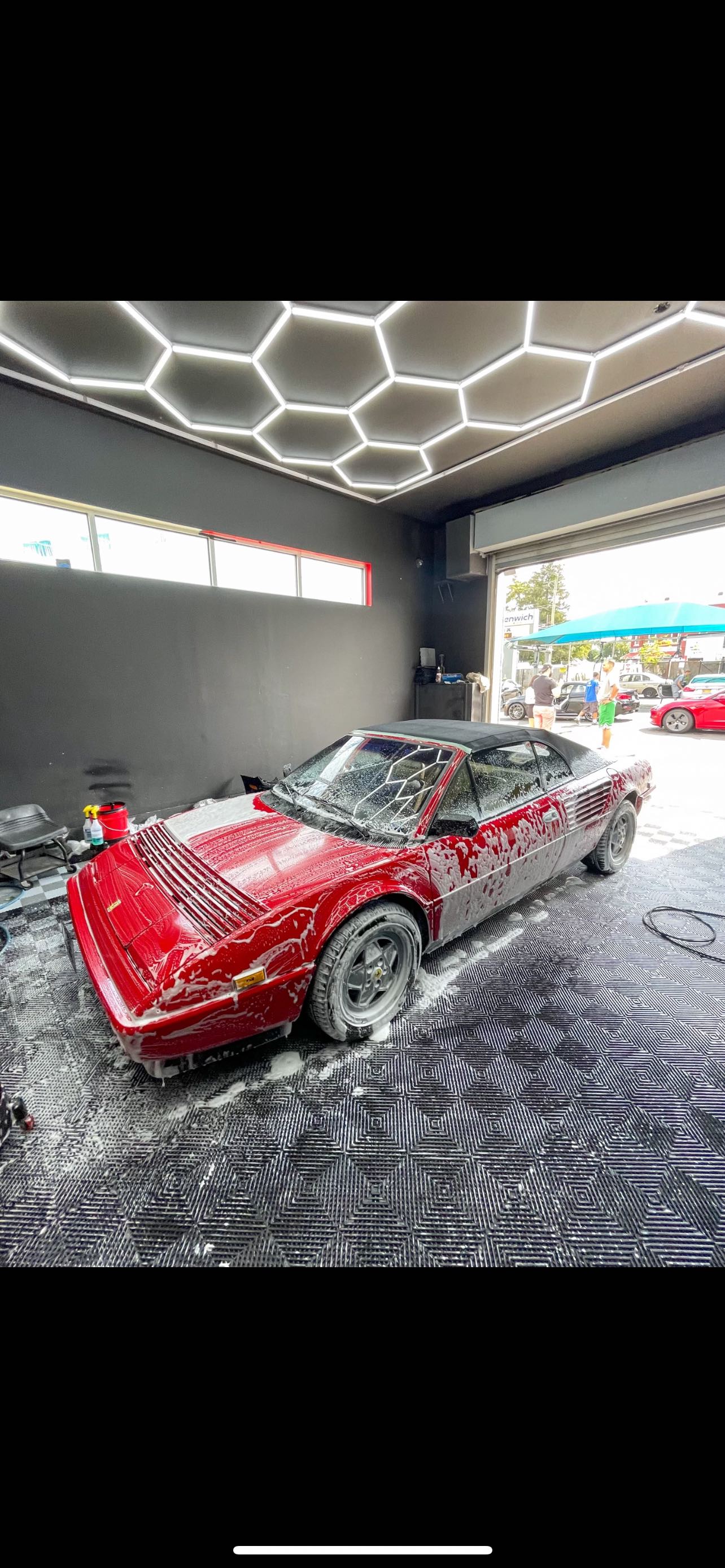 Classic red sports car foam wash with hexagonal ceiling